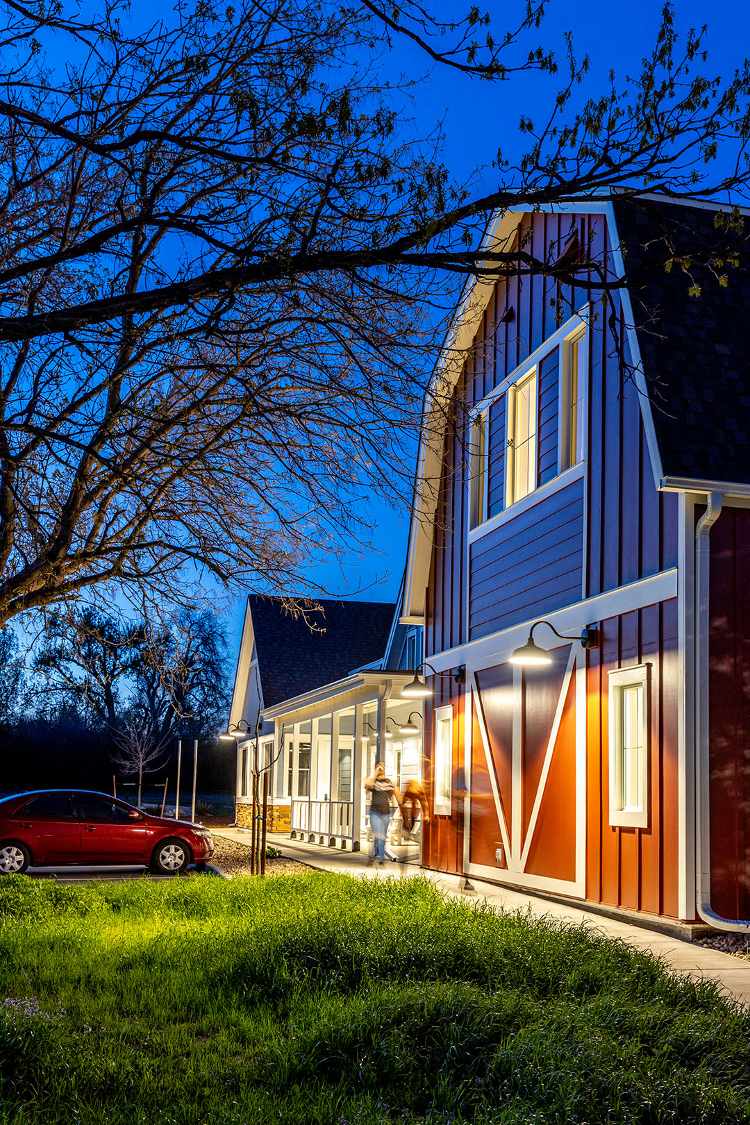 The new, modern red barn-style Homeward Bound facility at night